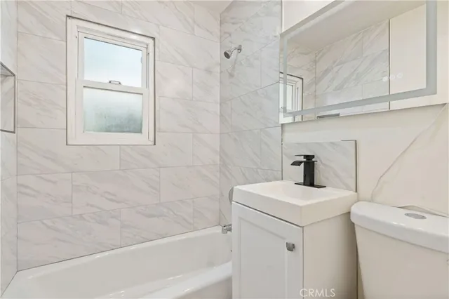 a bathroom with a sink a toilet and vanity