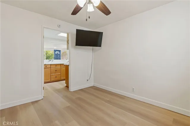 an empty room with windows and fireplace