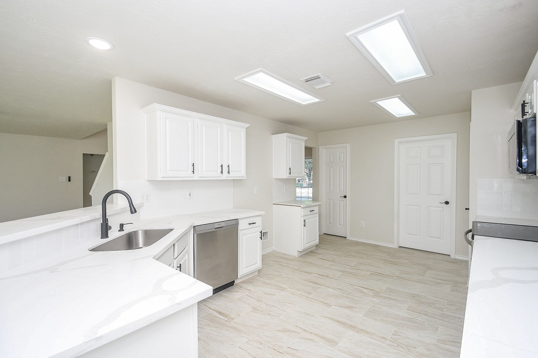 4810 Arbor Court Rosenberg, TX 77471 - Photo 8 of 20 a kitchen with a sink stove and cabinets