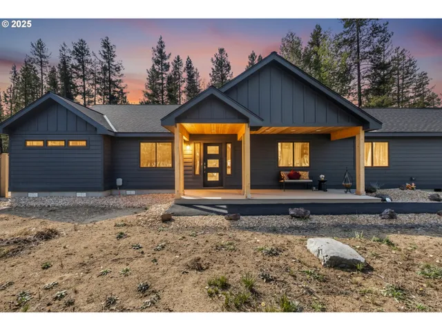 a view of a house with a yard and sitting area