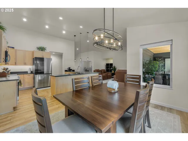 a view of kitchen and dining area with a chandelier