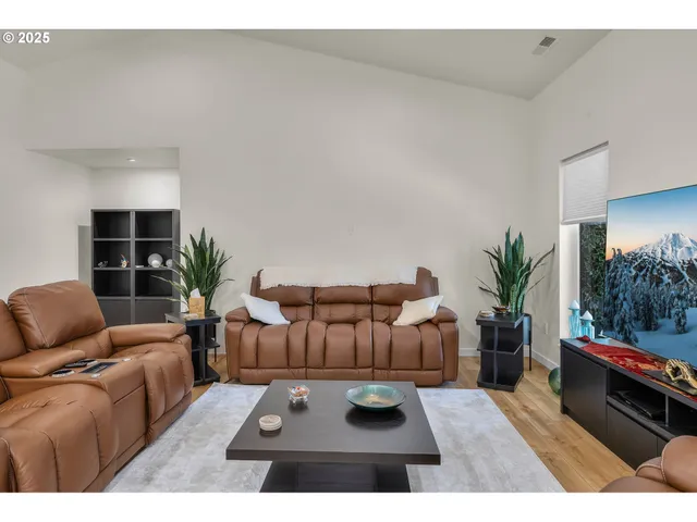 a living room with furniture and a potted plant