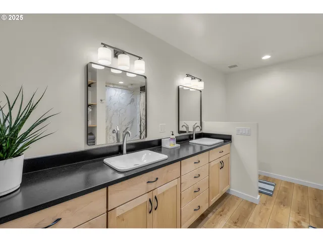 a bathroom with a double vanity sink and a mirror
