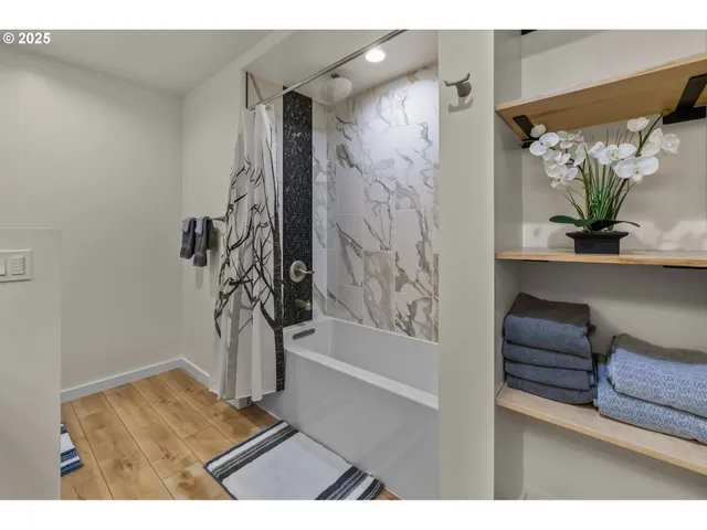 a view of bathroom with a tub and shower
