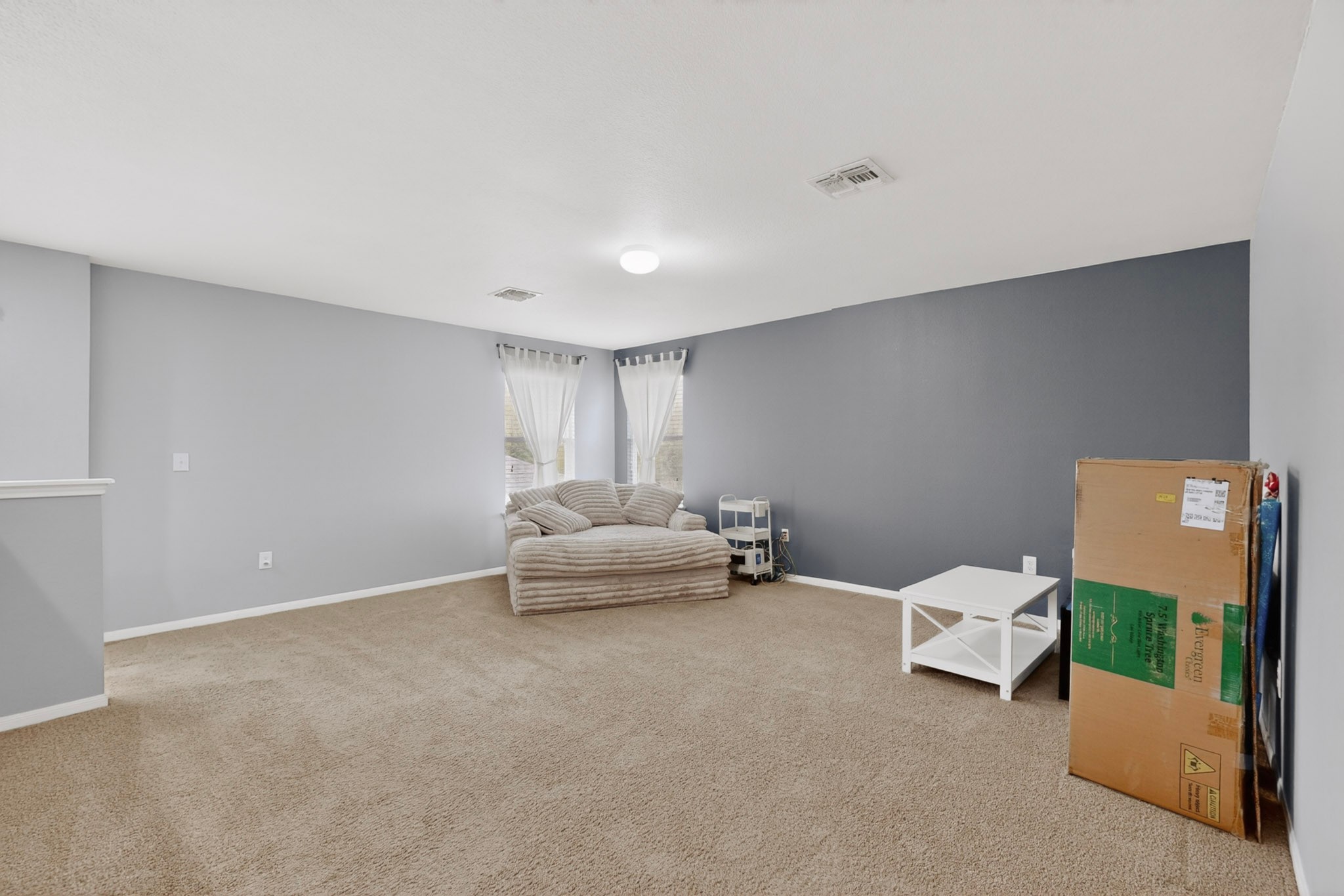 14513 Esker Road Manor, TX 78653 - Photo 13 of 38 A spacious and adaptable area features neutral carpeting and abundant light from multiple windows.
