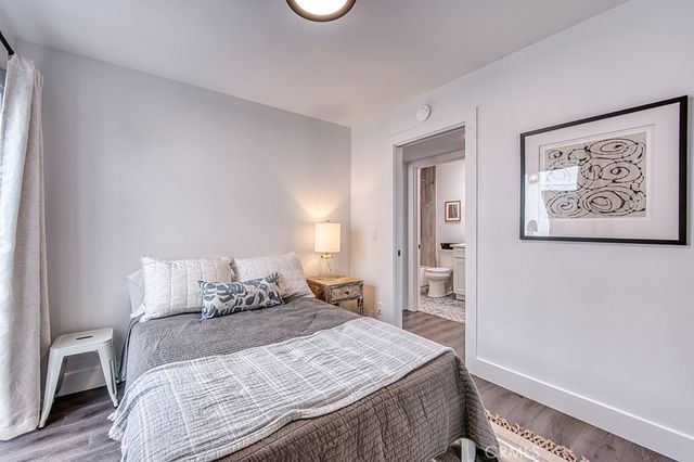 a bedroom with a bed and a painting on the wall