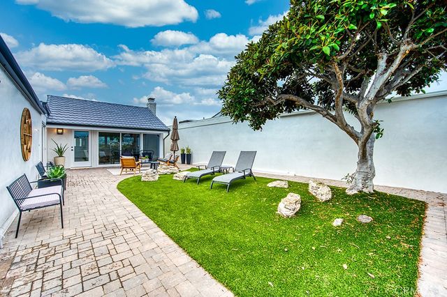 a backyard of a house with table and chairs