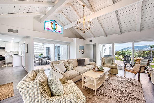 a living room with furniture ceiling fan and a rug