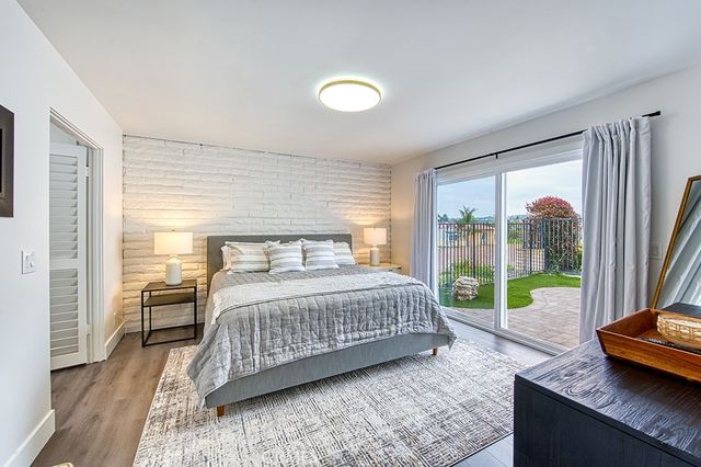 a bedroom with a bed and a large window