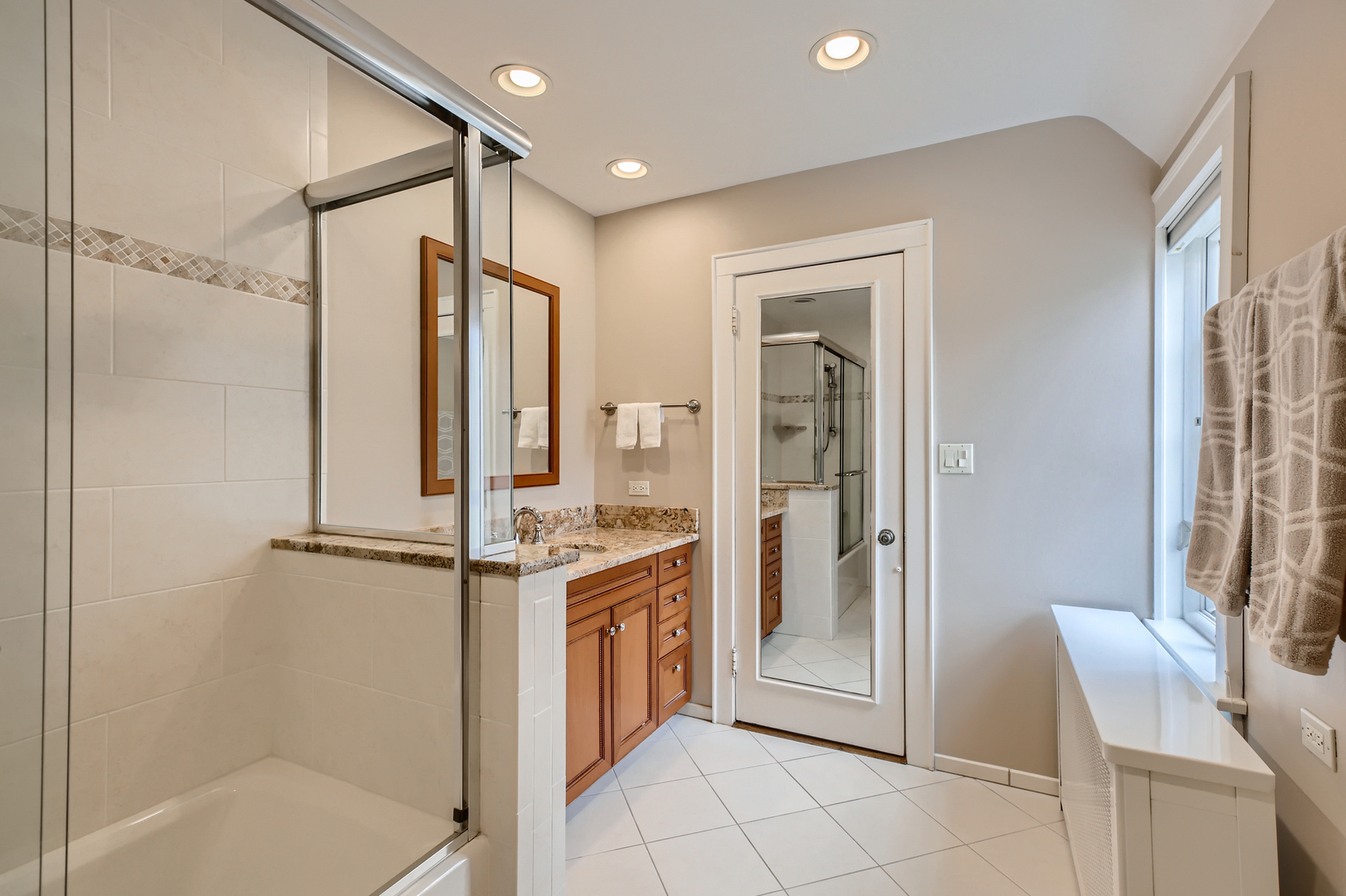 407 Brierhill Road Deerfield, IL 60015 - Photo 10 of 34 a bathroom with a granite countertop sink mirror and shower