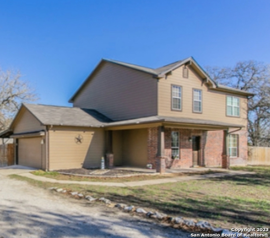 a view of a house with garden and yard