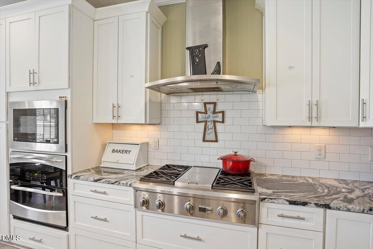 1001 Bellewood Farms Road Raleigh, NC 27603 - Photo 22 of 39 a stove top oven sitting inside of a kitchen