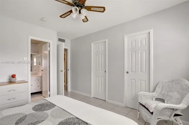 a living room with furniture and a ceiling fan