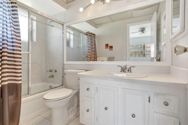 a bathroom with a granite countertop sink toilet a large mirror a vanity and shower
