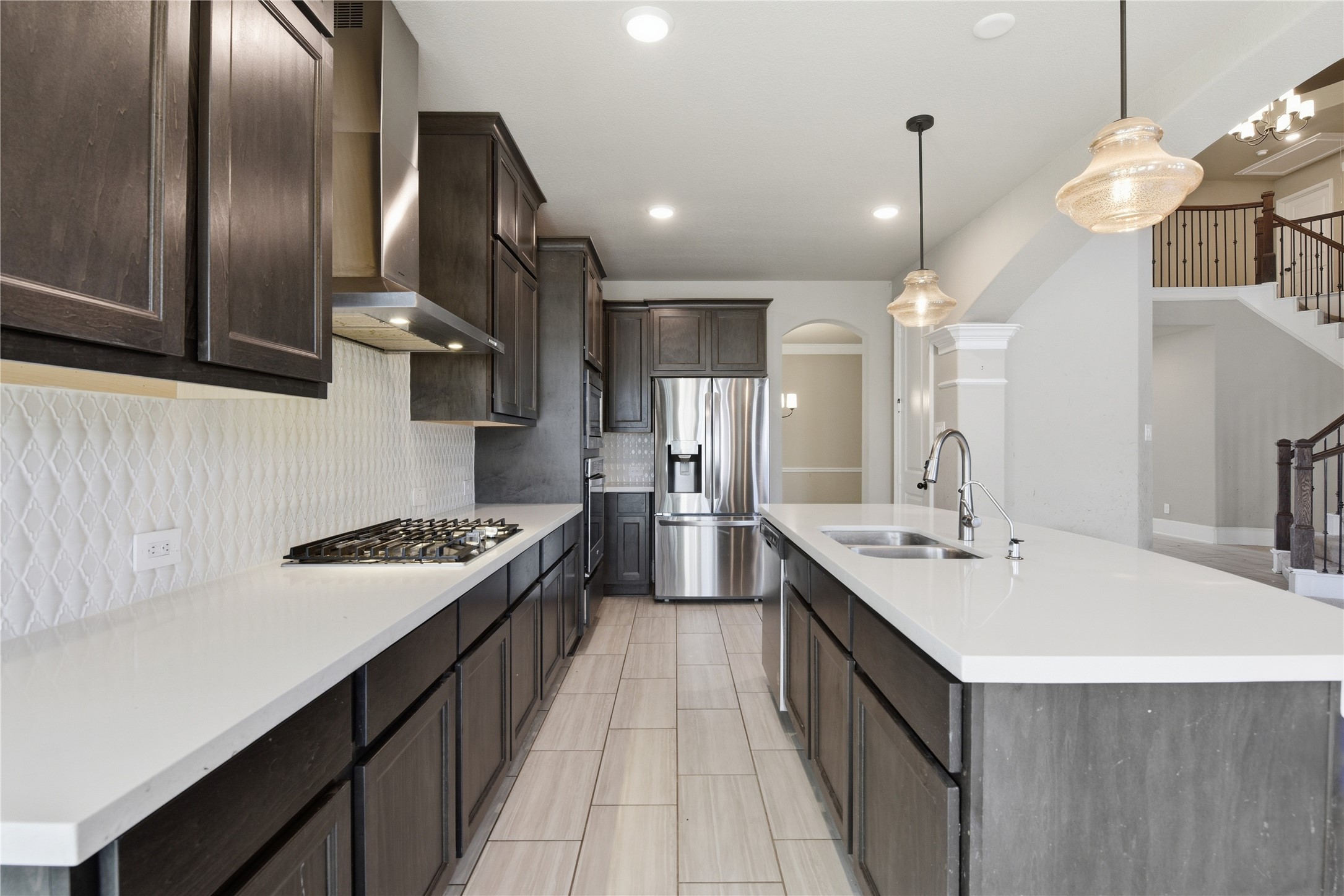 17501 Spice Merlot Lane Conroe, TX 77302 - Photo 21 of 50 a kitchen with stainless steel appliances a sink stove and cabinets