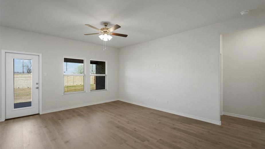 424 Epiphany Lane Lavon, TX 75166 - Photo 11 of 27 Spacious room featuring wood-finish flooring, light-toned walls, and a ceiling fan with integrated lighting