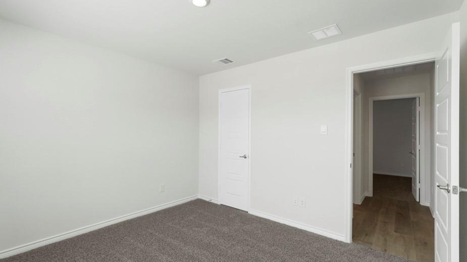 424 Epiphany Lane Lavon, TX 75166 - Photo 19 of 27 Carpeted room with light gray walls, white trim, and a flush-mounted ceiling light