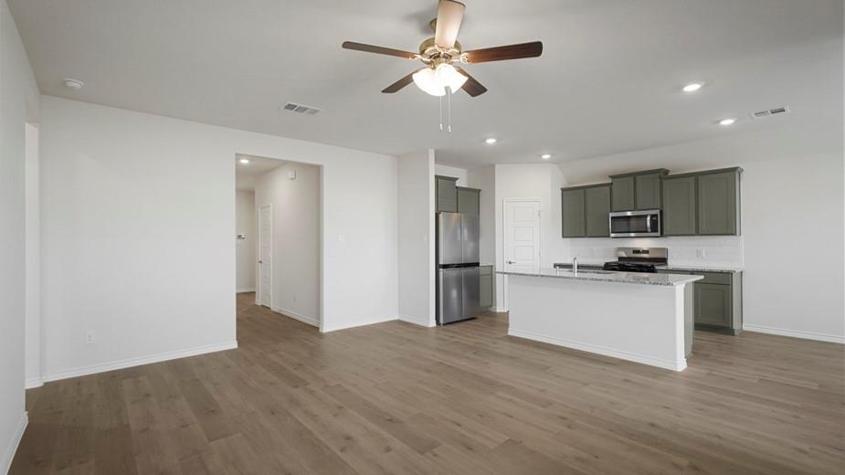 424 Epiphany Lane Lavon, TX 75166 - Photo 7 of 27 Open-concept living area with wood-finish flooring, a ceiling fan, and recessed lighting