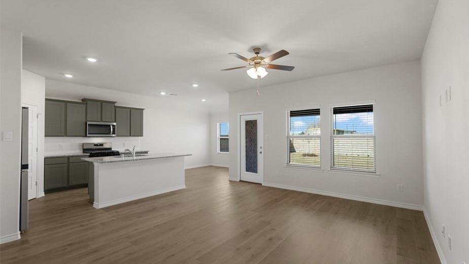 424 Epiphany Lane Lavon, TX 75166 - Photo 8 of 27 Open-concept living area featuring wood-finish flooring, a contemporary ceiling fan, and recessed lighting