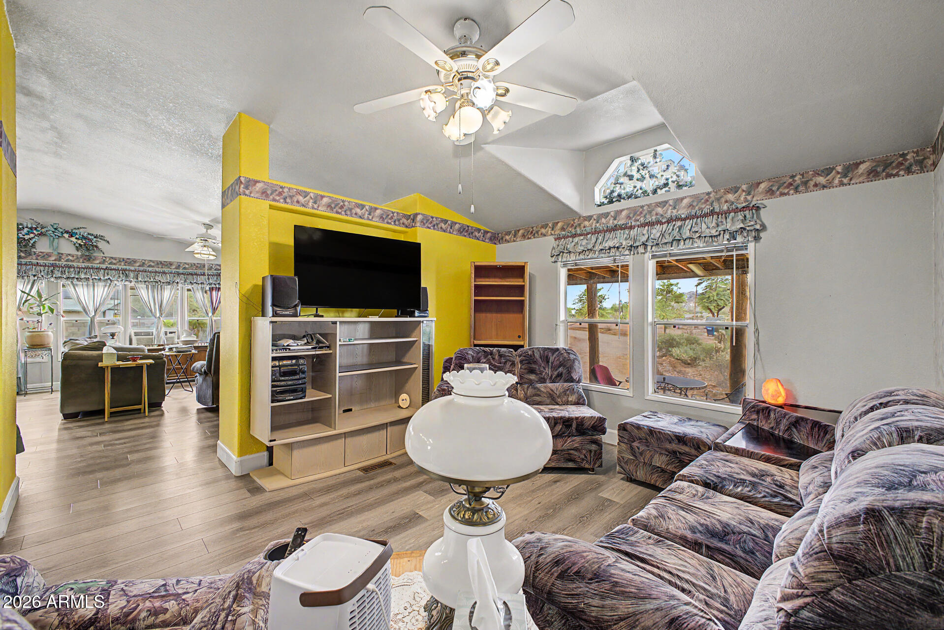 2548 South Val Vista Road Apache Junction, AZ 85119 - Photo 14 of 29 a living room with furniture a flat screen tv and a large window