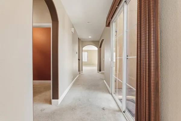 a view of a livingroom with wooden floor and windows