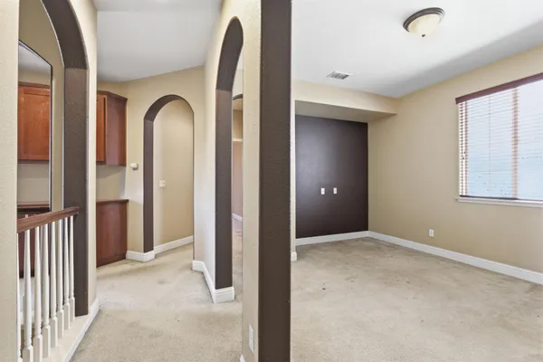 a bathroom with a double vanity sink a large mirror and a bathtub