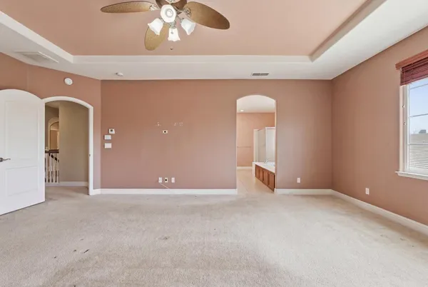 a large bathroom with a large tub sink and mirror
