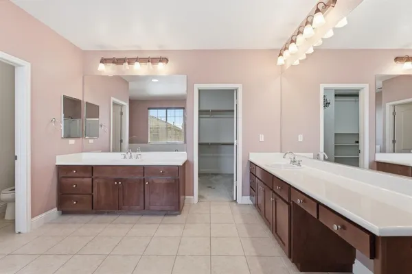 an empty room with windows and chandelier