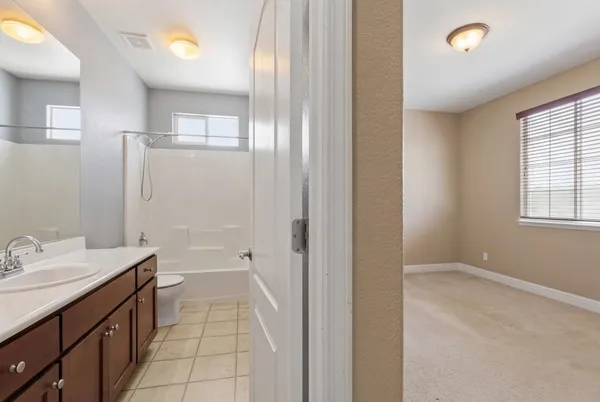 a bathroom with a double vanity sink and mirror with shower