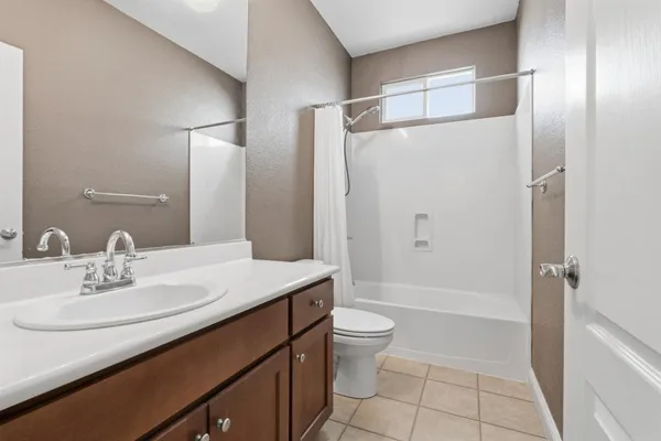 a backyard of a house with potted plants and brick wall