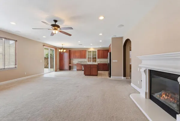 a large kitchen with a large counter top stainless steel appliances and cabinets