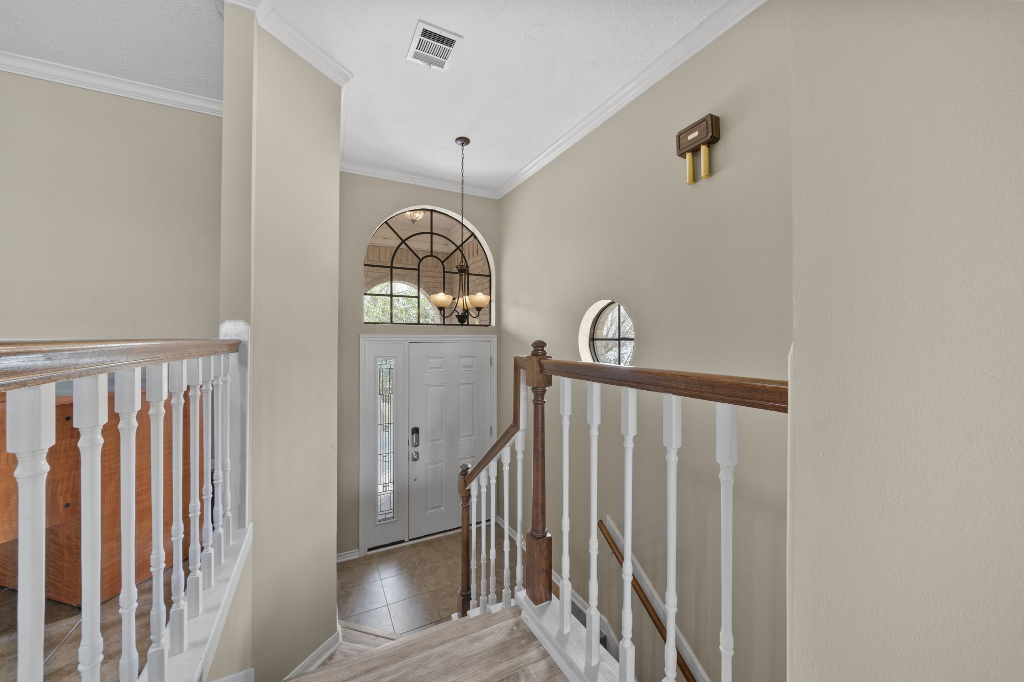 169 April Cove Montgomery, TX 77356 - Photo 10 of 39 This inviting staircase is conveniently located just off the entry, featuring elegant wood handrails, classic white balusters, and neutral tones that create a warm and welcoming transition to the second floor.