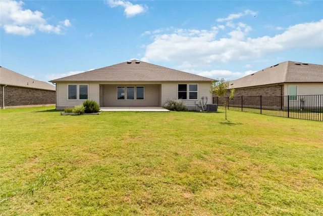 a view of a house with a swimming pool and deck