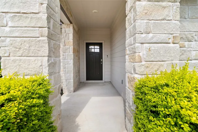 a view of a pathway with a flower garden