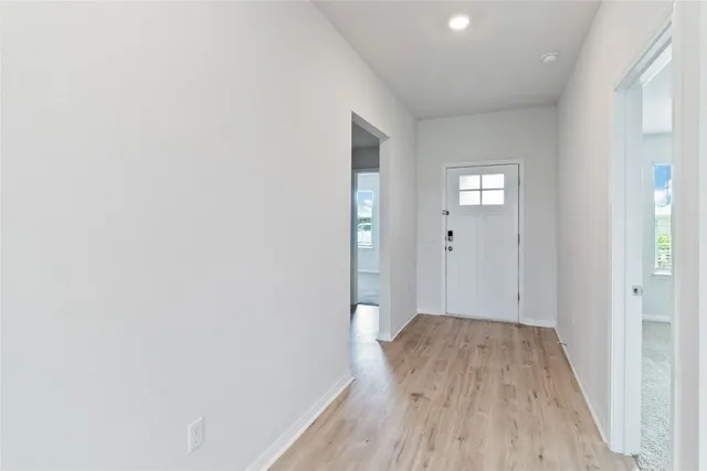 a view of hallway with wooden floor