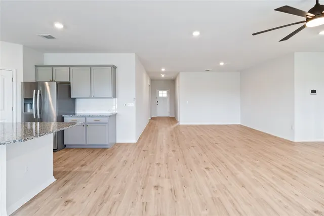 a large kitchen with kitchen island a sink stainless steel appliances and cabinets