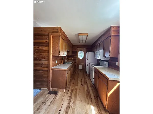 a bathroom with a granite countertop sink toilet a mirror and shower