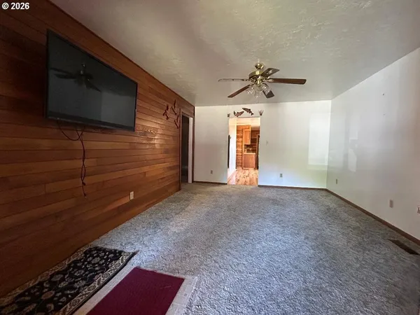 a view of livingroom with hardwood floor and a ceiling fan