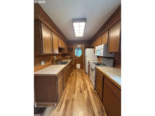 a kitchen with sink cabinets and appliances