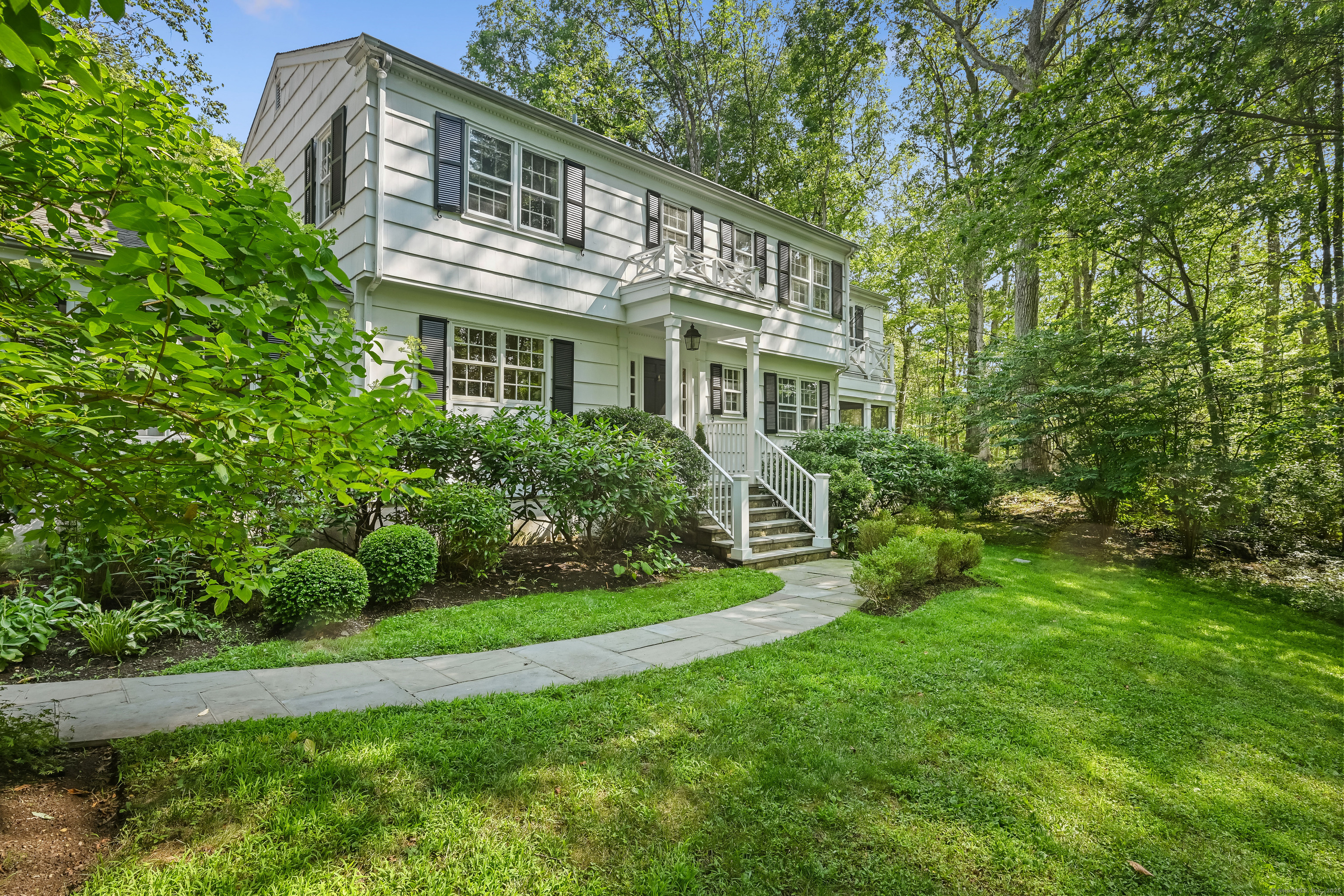 81 Mariomi Road New Canaan, CT 06840 - Photo 1 of 1 a front view of a house with a garden