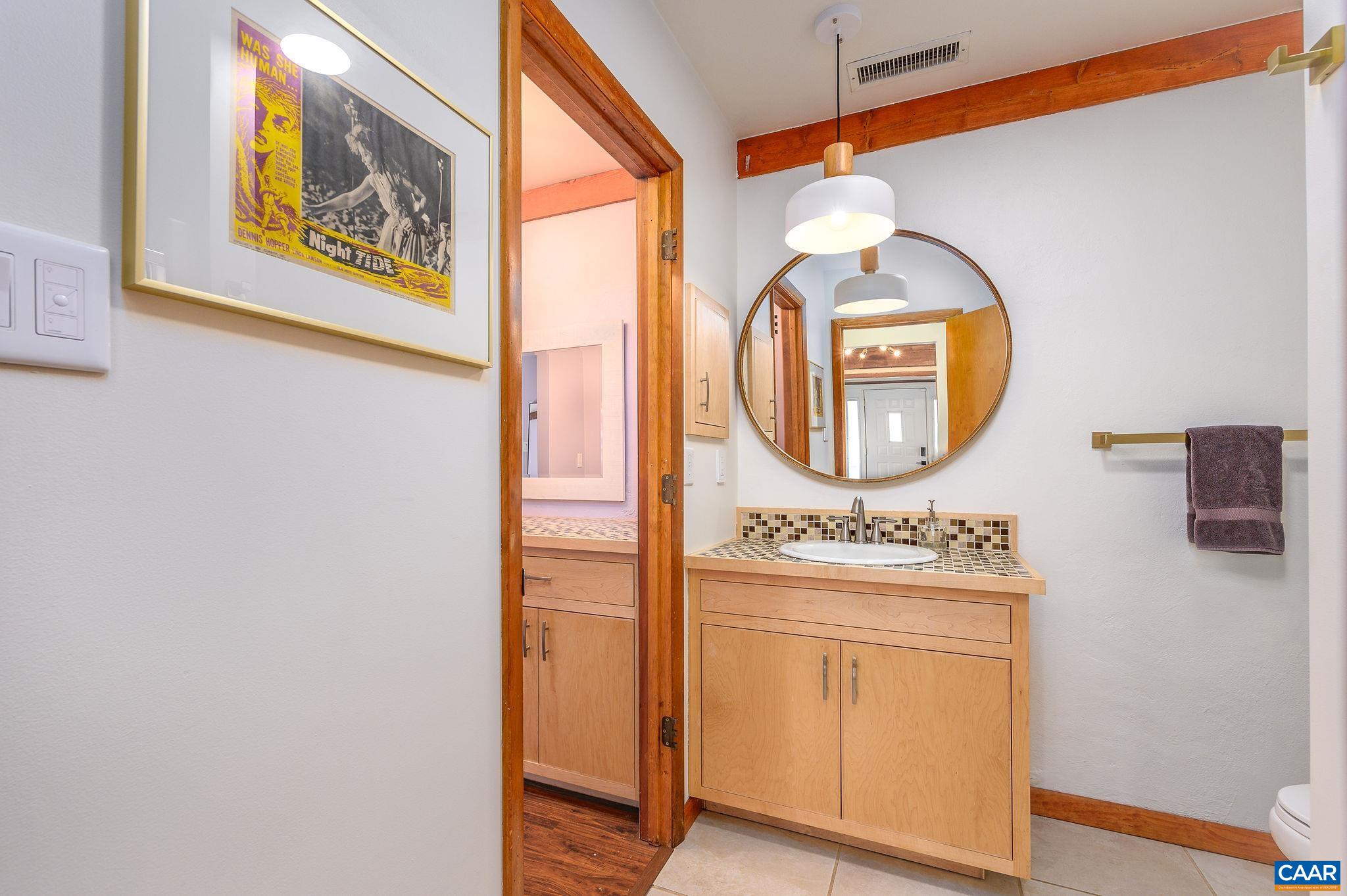 9663 Dyke Road Dyke, VA 22935 - Photo 17 of 55 an entryway with wooden floor mirror and a table