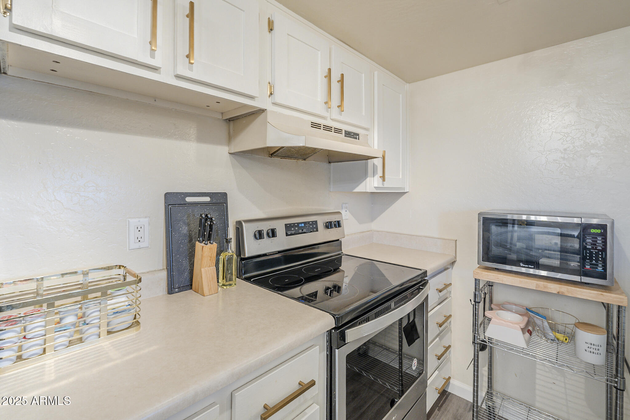 12123 West Bell Road, Unit 260 Surprise, AZ 85378 - Photo 11 of 29 a kitchen with a stove and a microwave