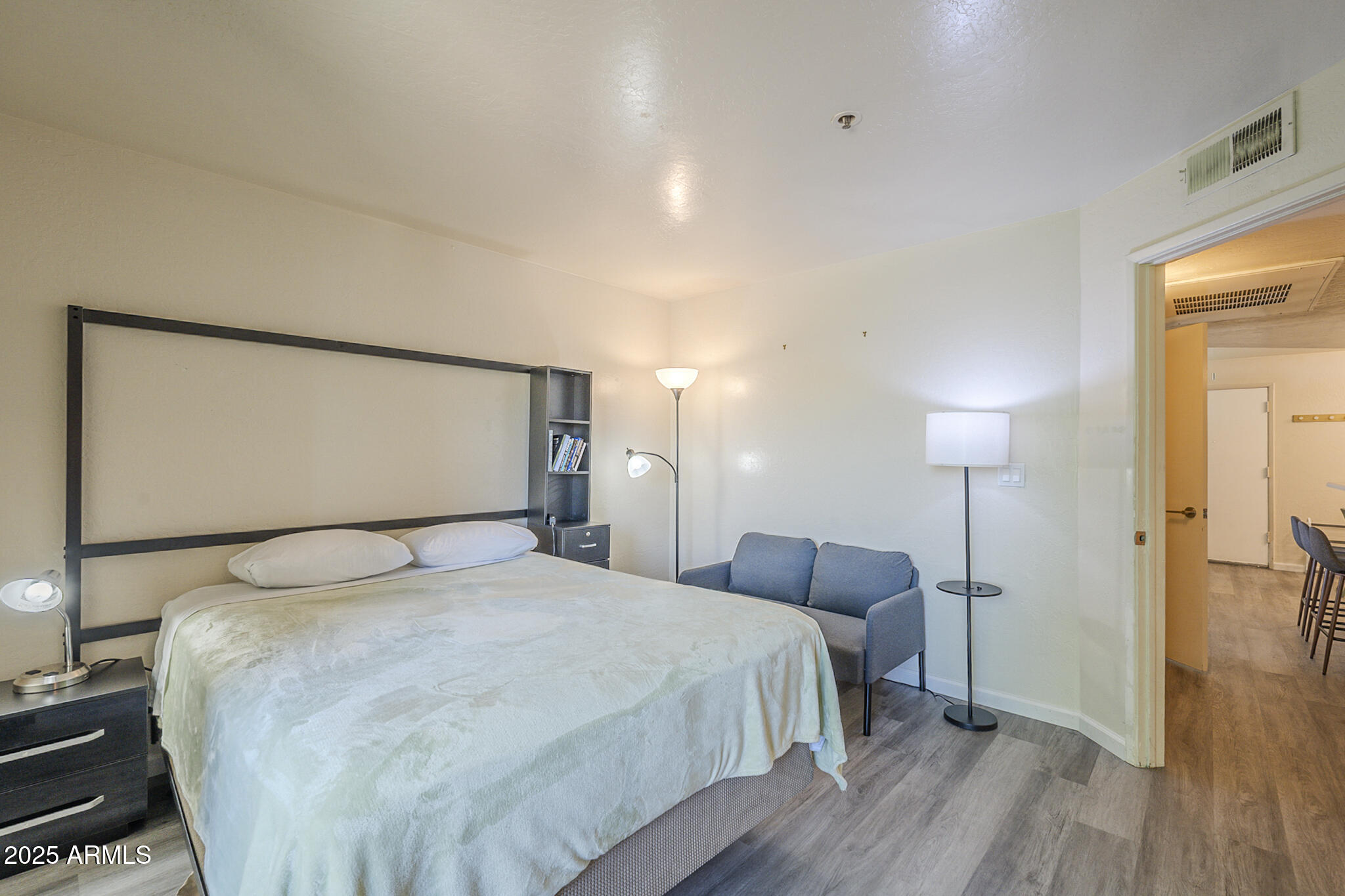 12123 West Bell Road, Unit 260 Surprise, AZ 85378 - Photo 14 of 29 a bedroom with a bed and a mirror