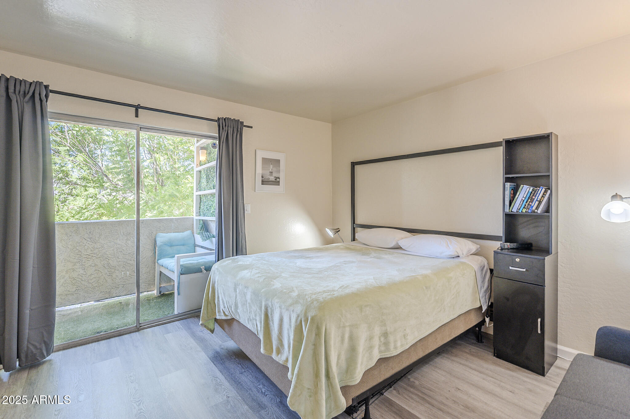 12123 West Bell Road, Unit 260 Surprise, AZ 85378 - Photo 16 of 29 a bedroom with a bed and large window