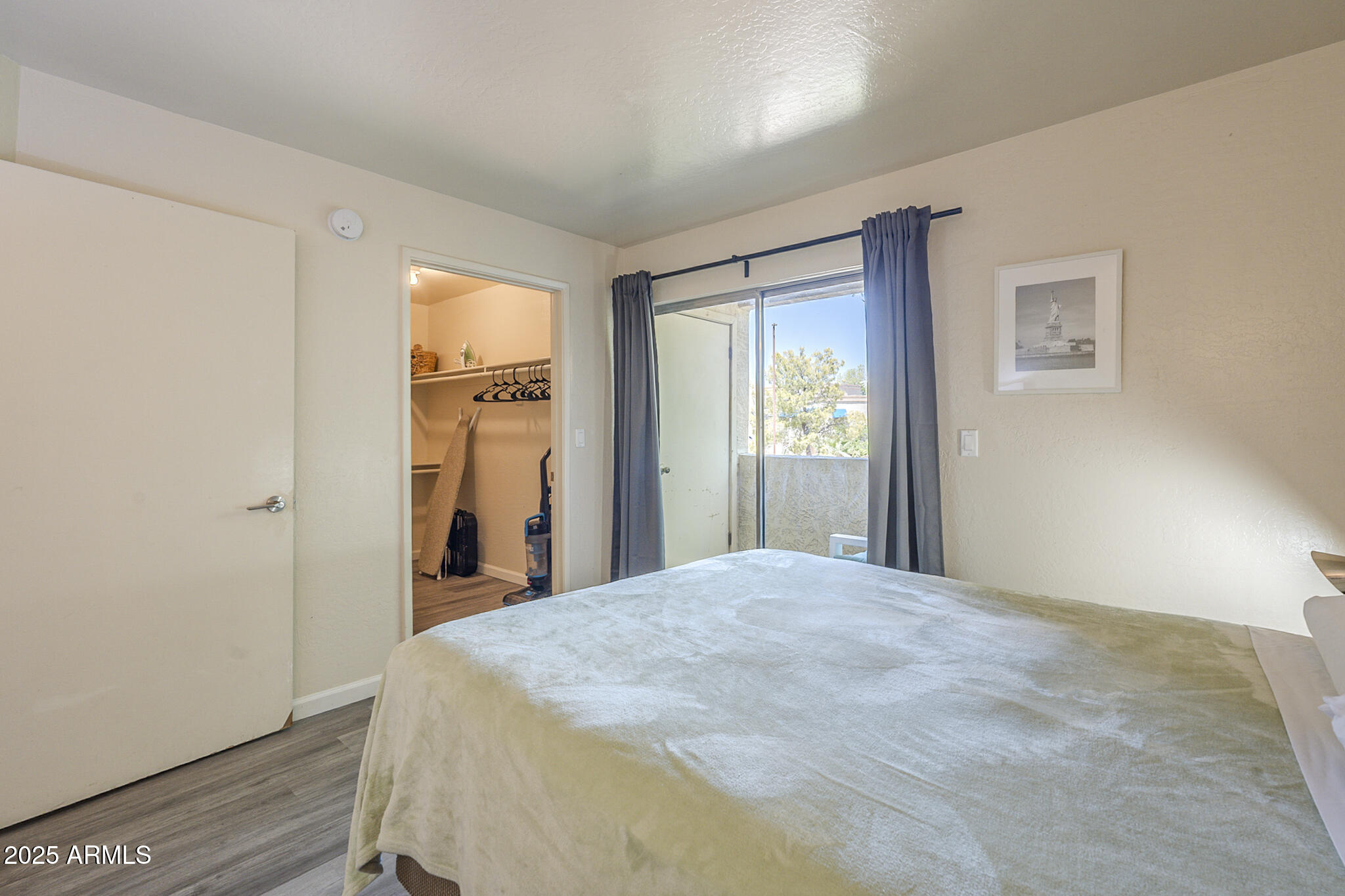 12123 West Bell Road, Unit 260 Surprise, AZ 85378 - Photo 17 of 29 a large bed in a bedroom next to a window