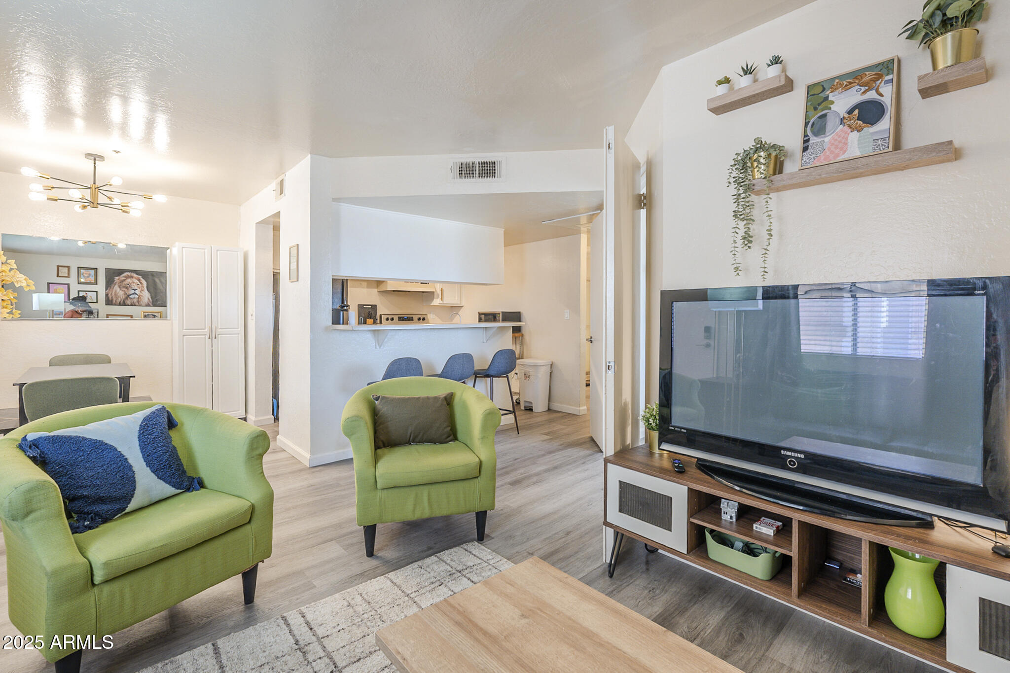12123 West Bell Road, Unit 260 Surprise, AZ 85378 - Photo 2 of 29 a living room with furniture and a flat screen tv