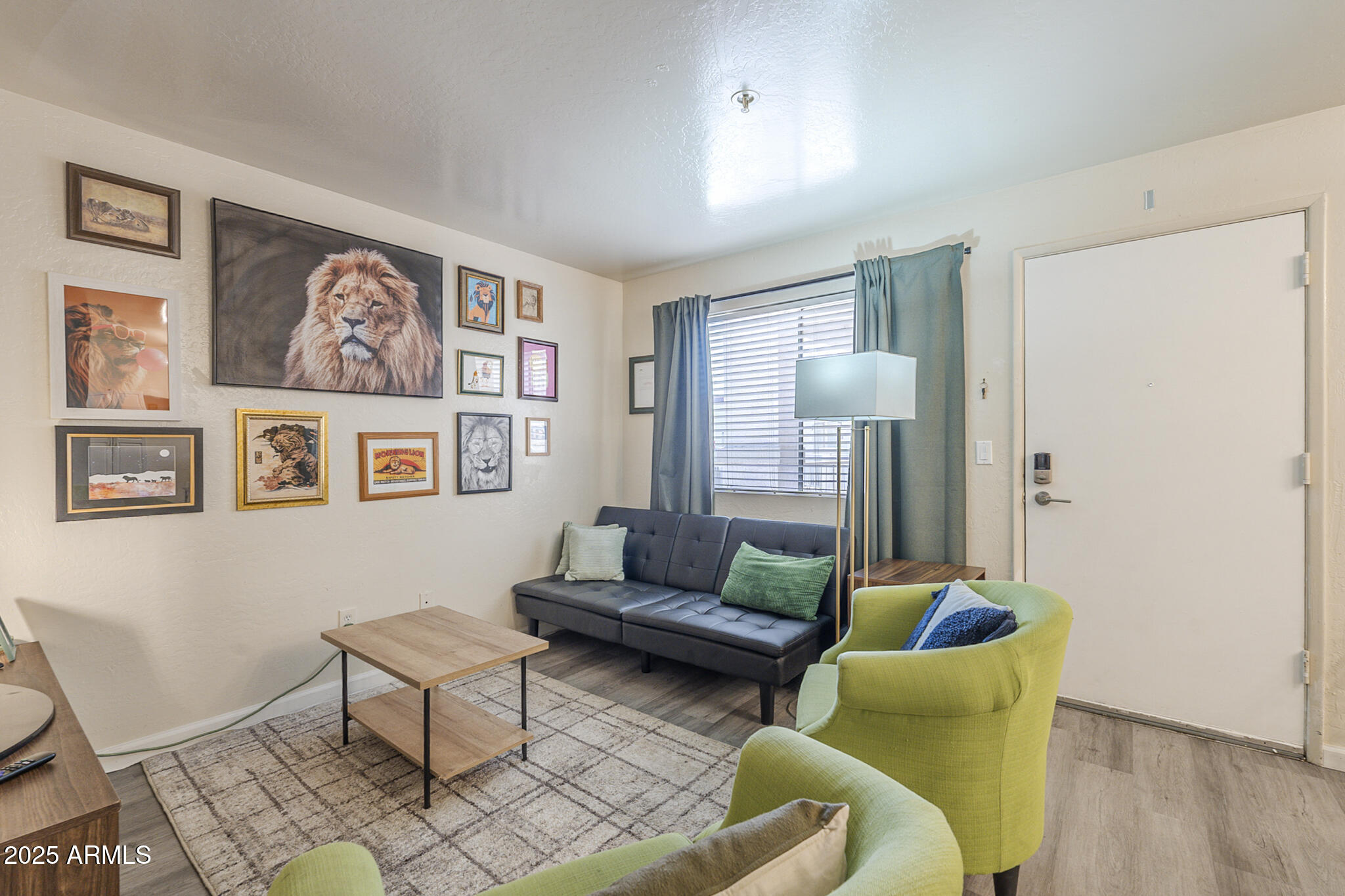 12123 West Bell Road, Unit 260 Surprise, AZ 85378 - Photo 3 of 29 a living room with furniture and painting on the wall
