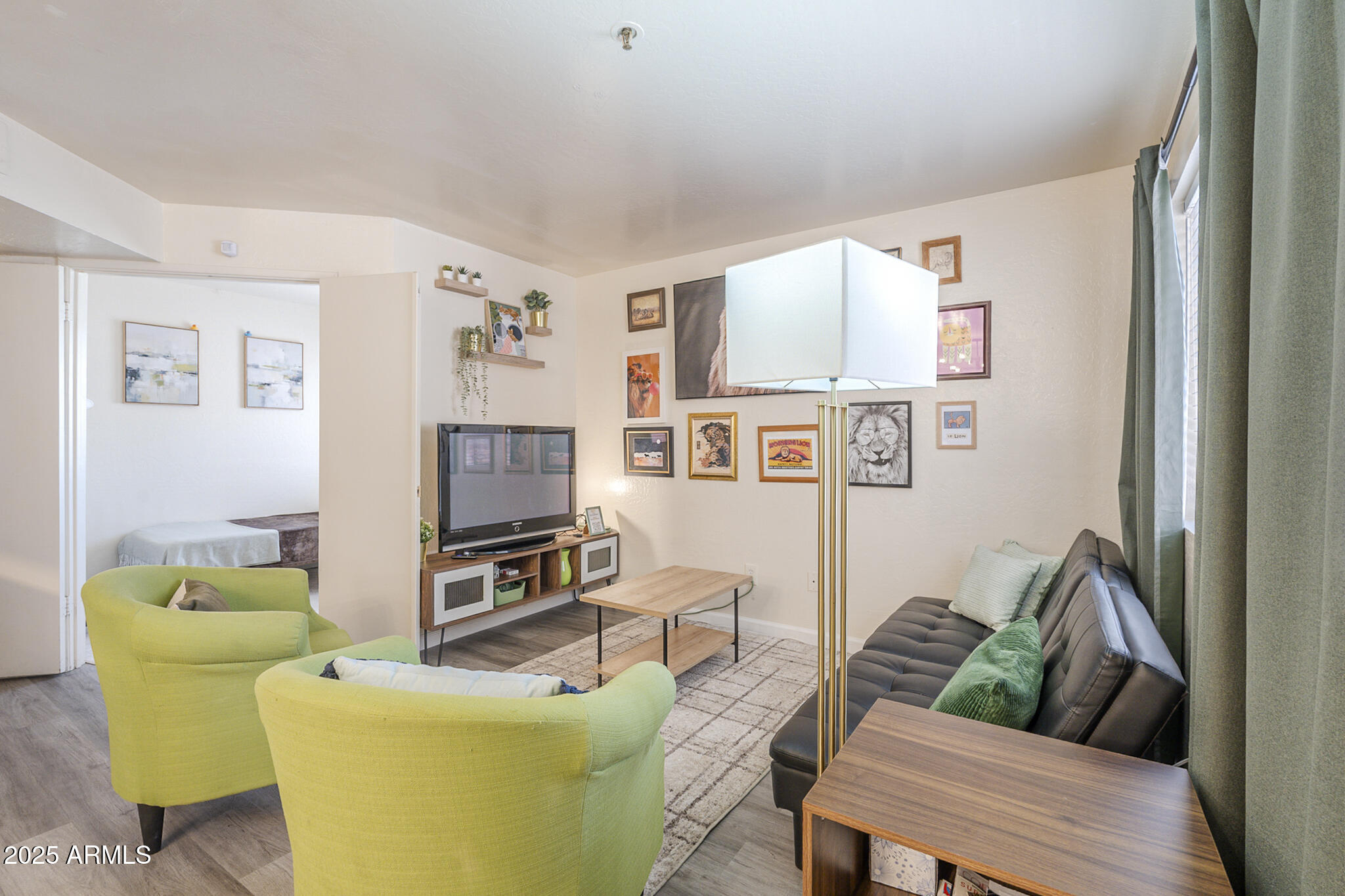12123 West Bell Road, Unit 260 Surprise, AZ 85378 - Photo 4 of 29 a living room with furniture and a flat screen tv