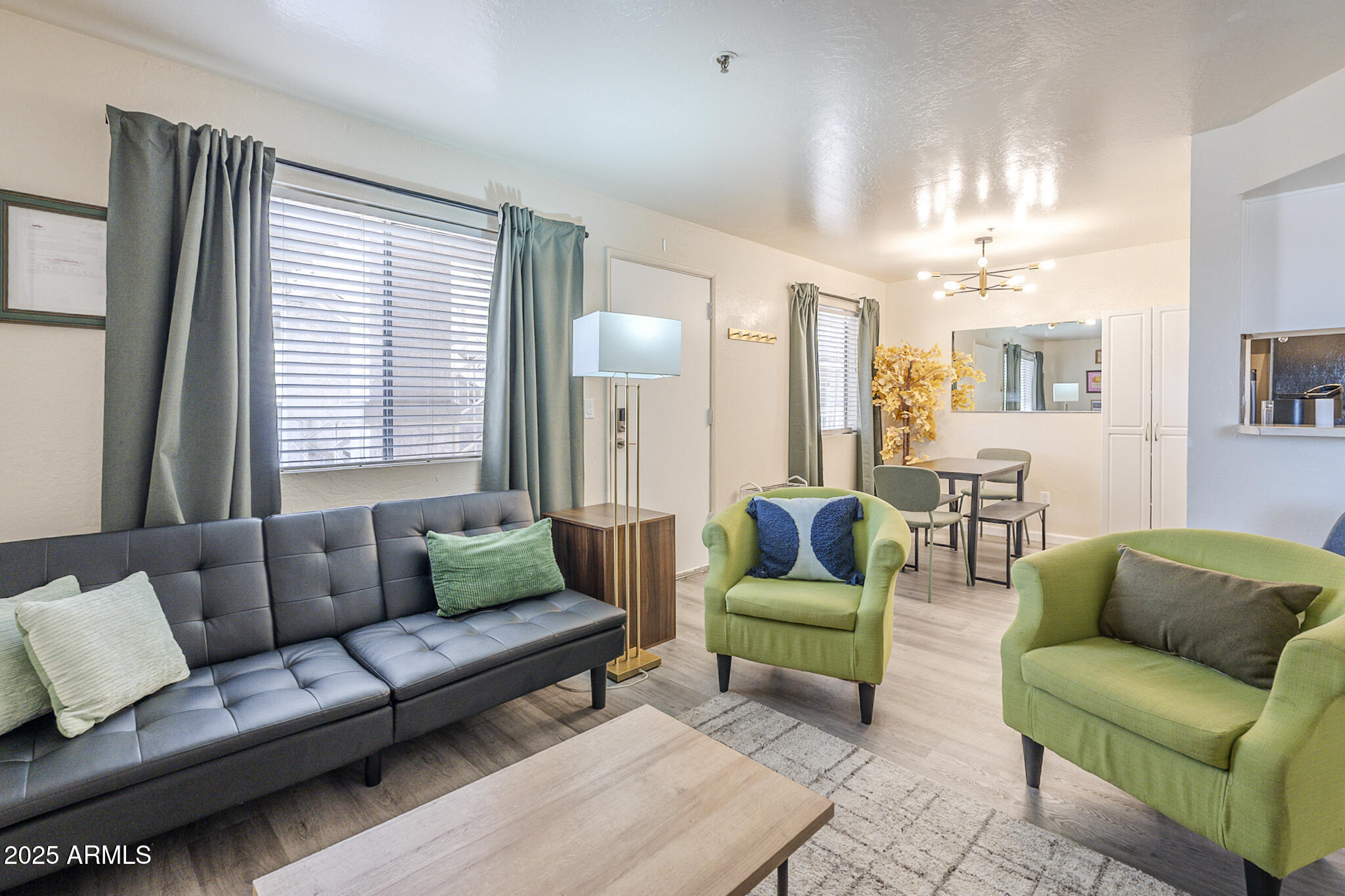 12123 West Bell Road, Unit 260 Surprise, AZ 85378 - Photo 5 of 29 a living room with furniture and a large window