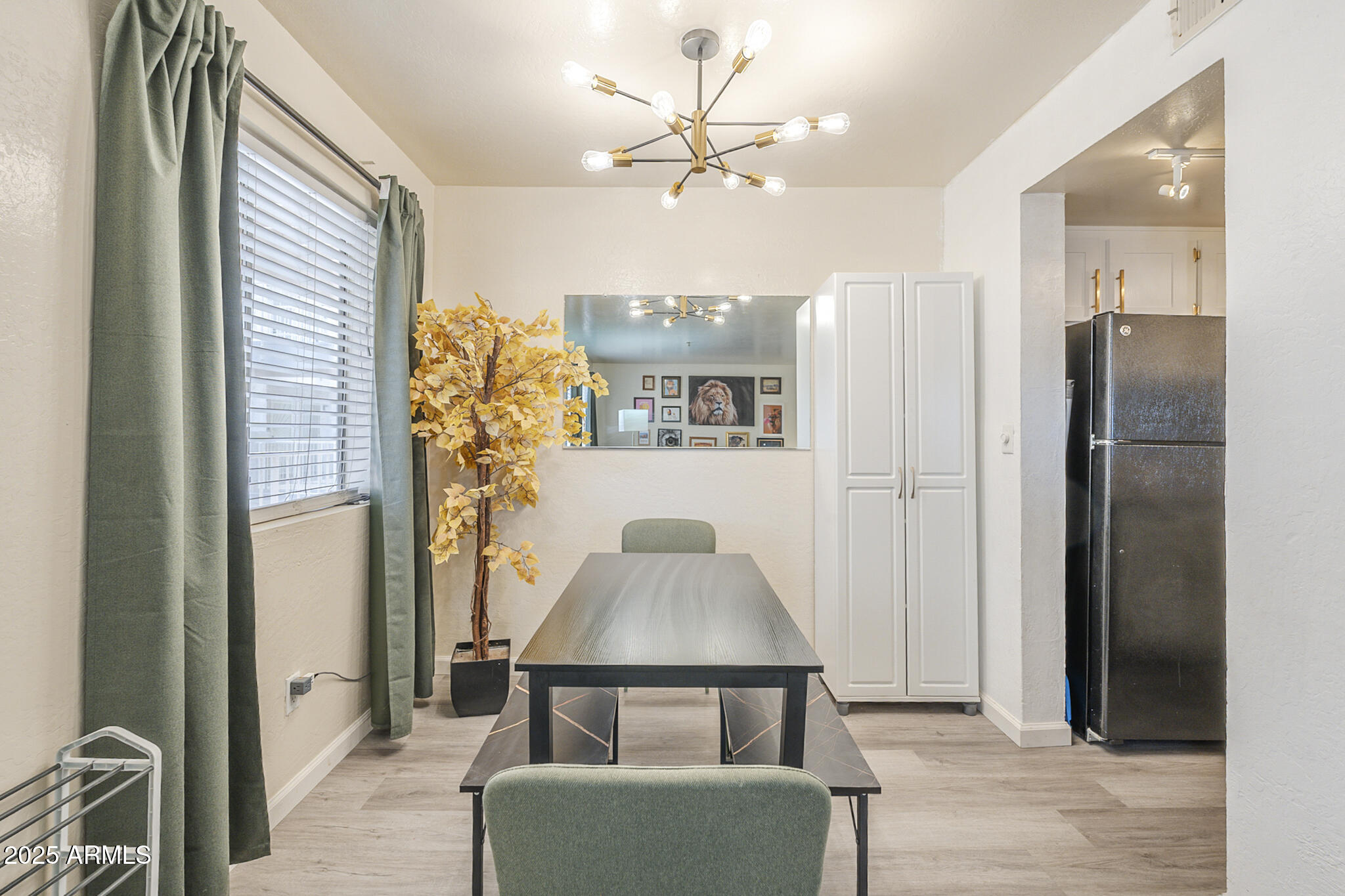 12123 West Bell Road, Unit 260 Surprise, AZ 85378 - Photo 6 of 29 a living room with furniture and a chandelier
